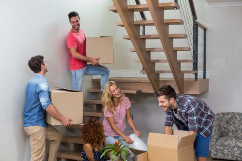 Professional furniture pickup team removing a sofa from a home