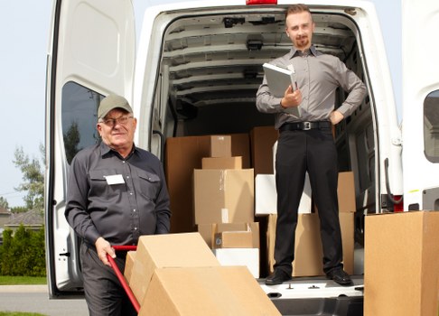 Professional movers loading furniture into a moving truck