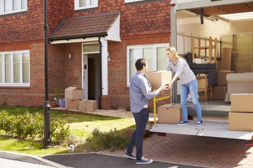 Man and van team transporting a sofa and chairs