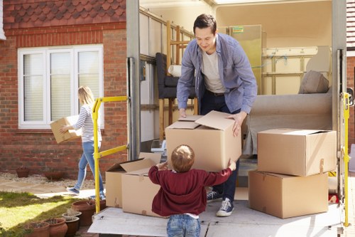 Movers handling furniture safely during a removal job