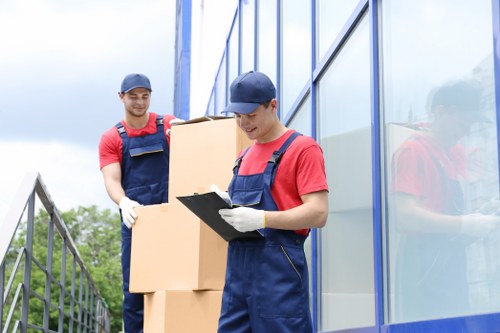 Student moving furniture into a shared accommodation room