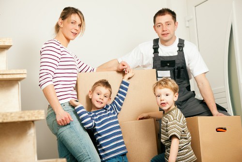 Professional movers loading a sofa for same day removal