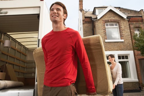 Furniture being moved carefully through a flat hallway