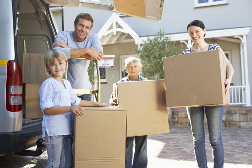 Movers carrying a heavy wardrobe through a doorway