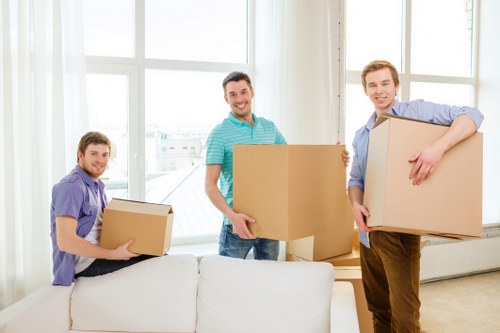 Professional movers lifting a large cabinet during furniture relocation