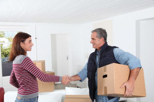 Professional movers carrying a wardrobe through a doorway