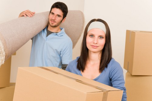 Furniture pickup service loading chairs and tables into a truck