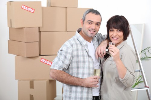 Professional movers preparing office furniture for safe relocation